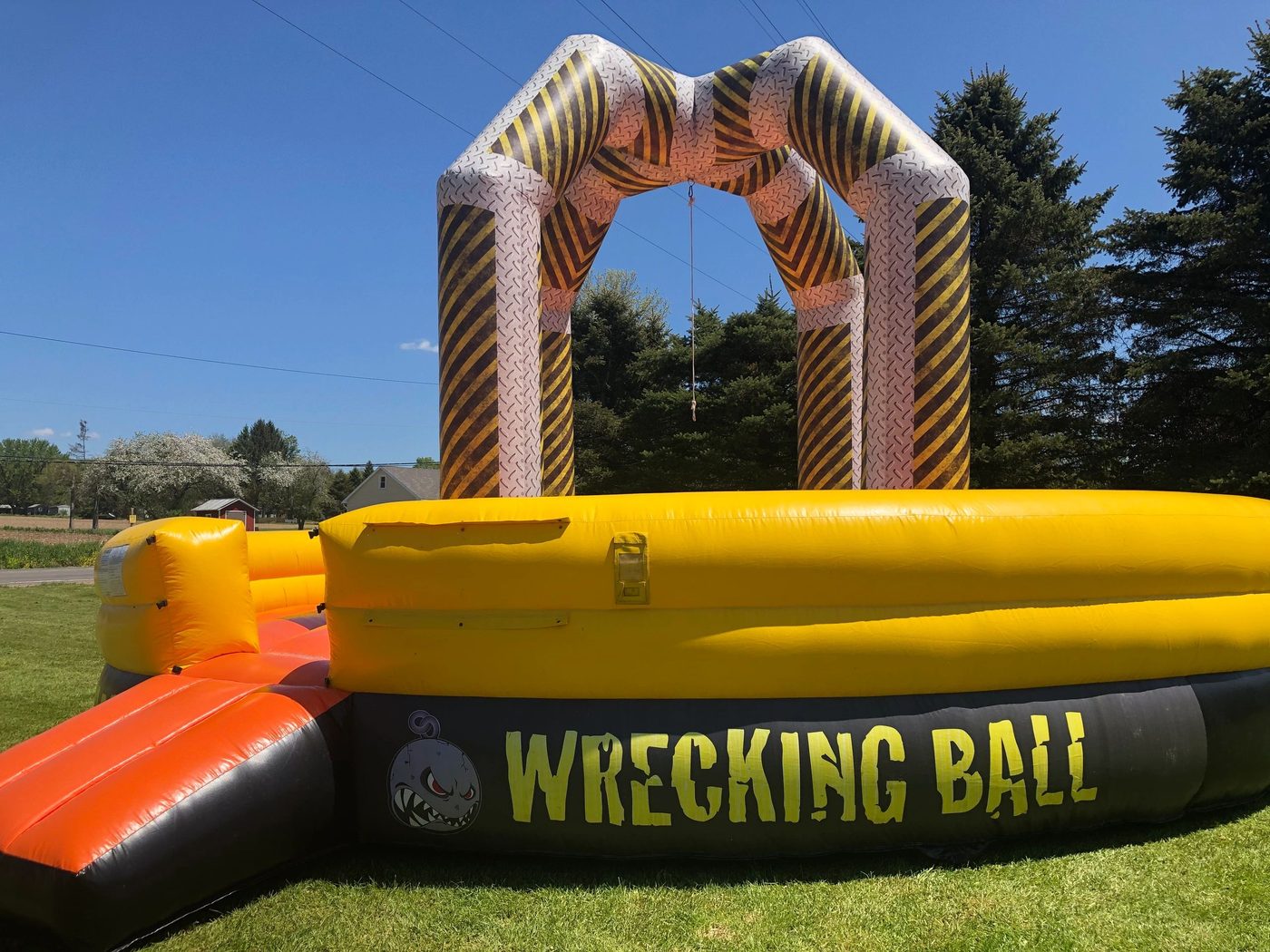 Just Bounce Around Wrecking Ball inflatable game on a sunny lawn